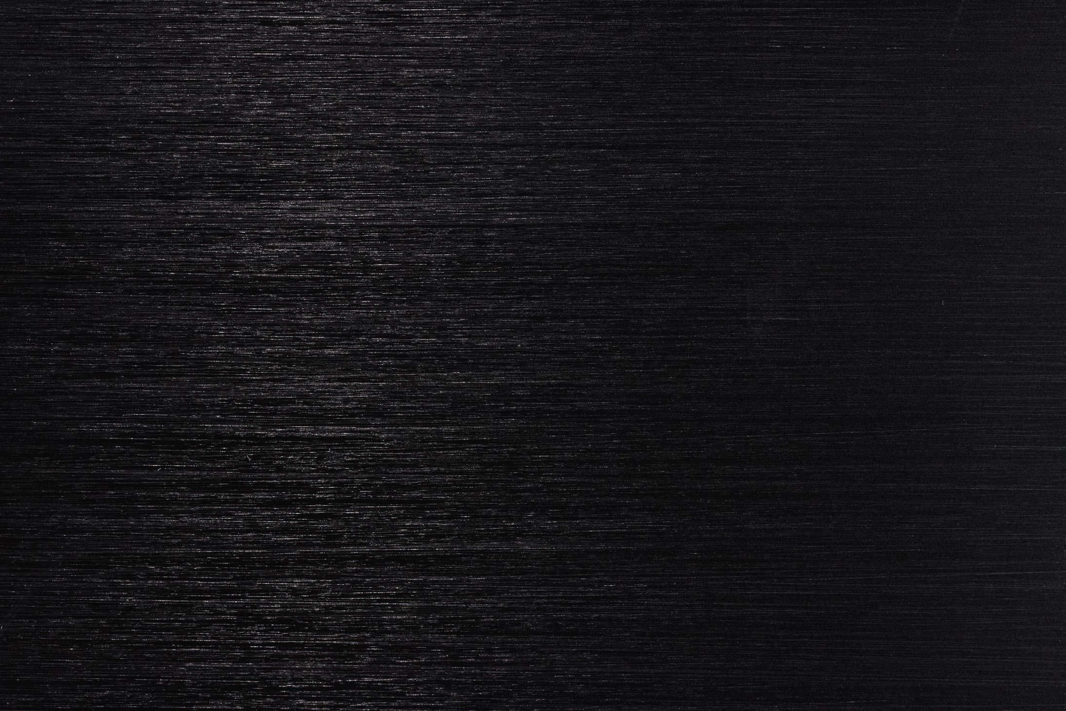 Dark metallic texture with white lines. Top view